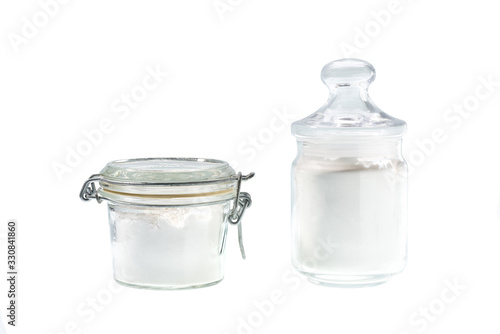 Glass jar with corn  starch isolated on a white background.