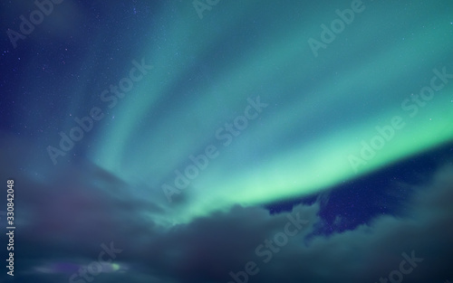Aurora Borealis, Senja Islands, Norway. Stars, moving clouds and northern light. Night landscape. Natural background. Travel - image