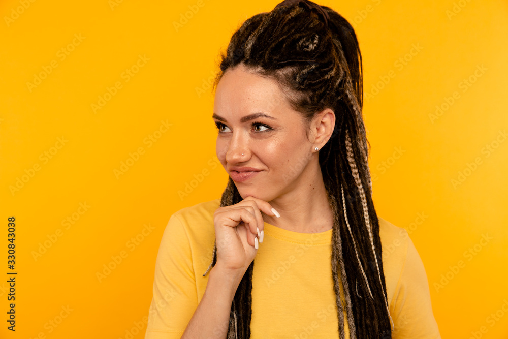 Thinking and posing woman on the yellow studio Thinking and posing woman on the yellow studio