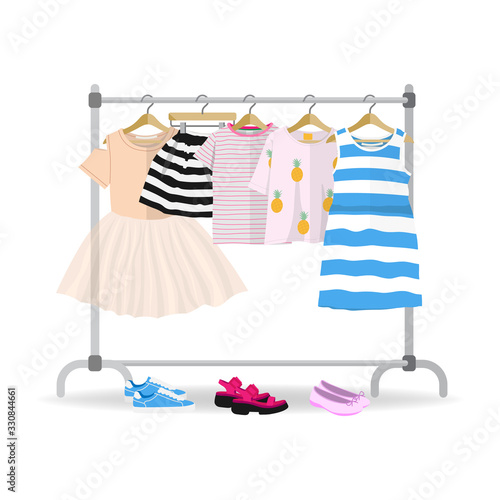 Rack with colorful summer children clothes hanging on hangers