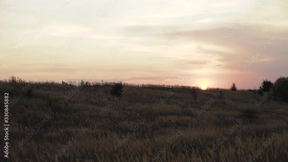 View of beautiful sunset on wild nature with spaces with grass View of beautiful sunset on wild nature with spaces with grass