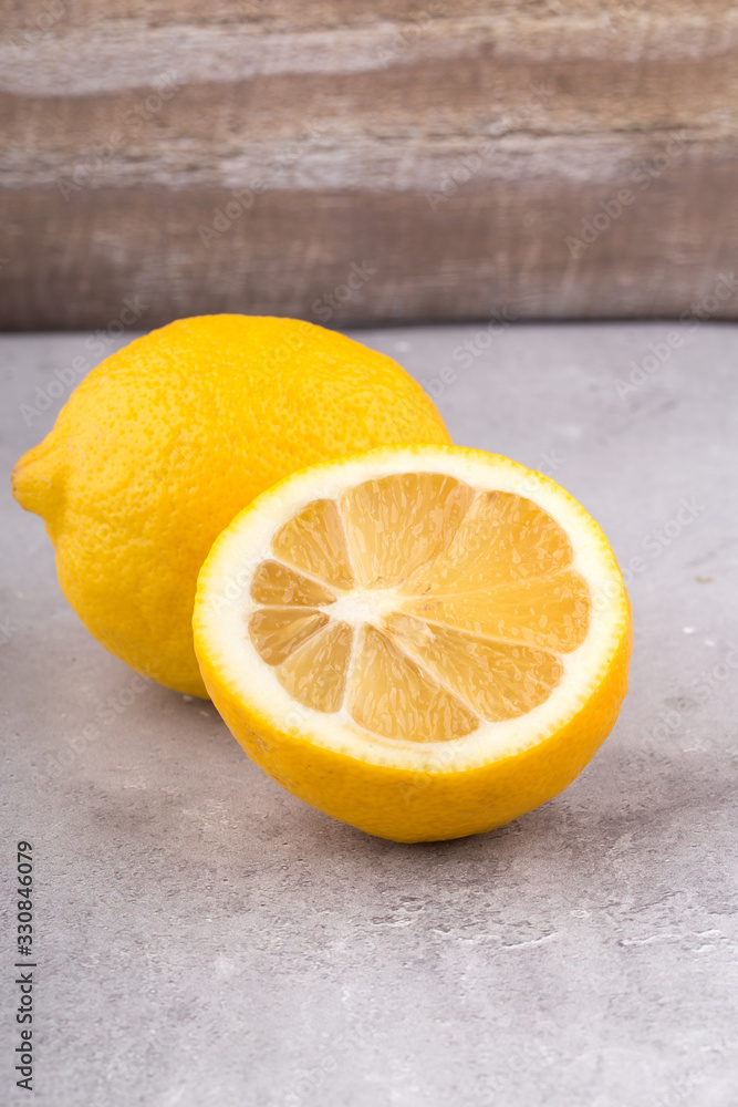 Fresh lemon on a grey background, vertical format. Fresh lemon on a grey background, vertical format.