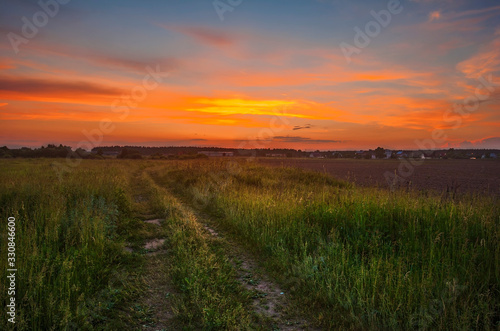 Road in sunset field