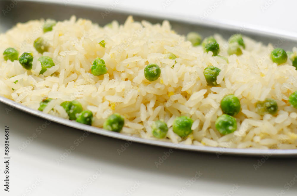 Egg fried rice served on the metal tray, an addition to an Indian or Asian main course Egg fried rice served on the metal tray, an addition to an Indian or Asian main course