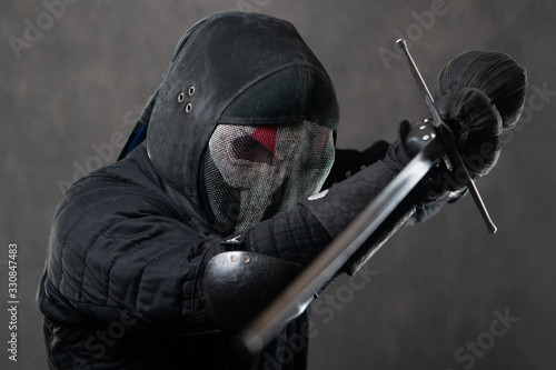 Obraz na plátně A man in a scary mask with a beard with a skid swords