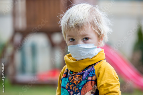 Toddler boy, child, wearing protective mask agains viruses