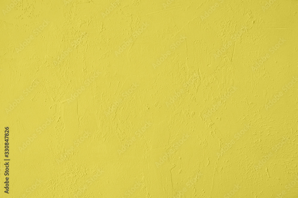 Saturated yellow colored low contrast Concrete textured background with roughness and irregularities. 2020, 2021 color trend. Saturated yellow colored low contrast Concrete textured background with roughness and irregularities. 2020, 2021 color trend.