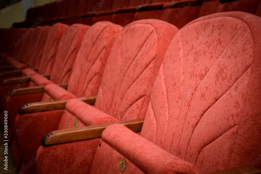 Row of red empty seats in theatre