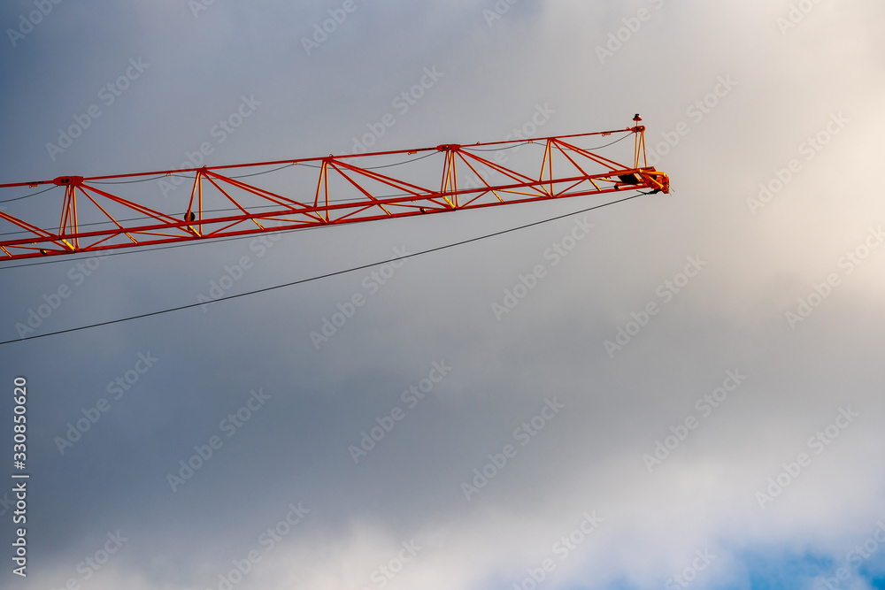 Tip of a construction crane on cloudy storm sky Tip of a construction crane on cloudy storm sky