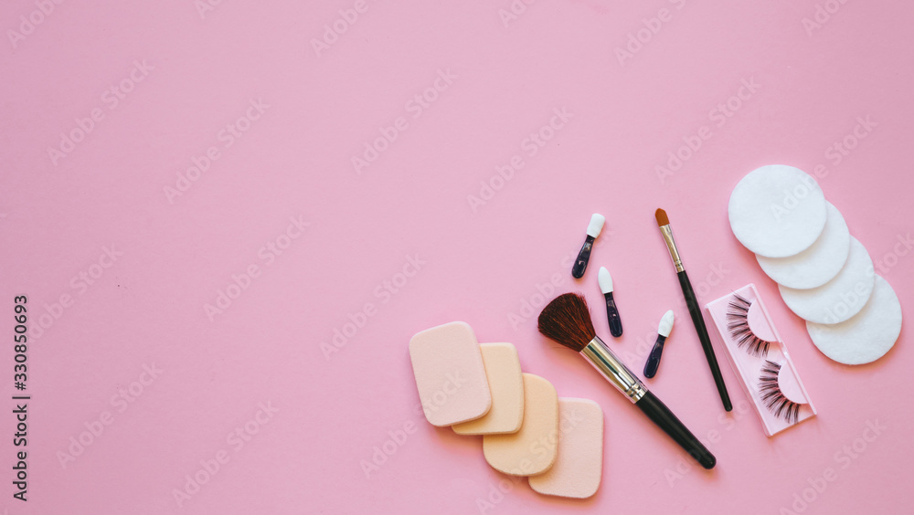 Professional makeup tools. Makeup tools brushes, eyelashes, nail polish, creme ,cotton pads, perfume, applicators on pink background. Cosmetics for beauty.Top view with copy space Flat lay. Professional makeup tools. Makeup tools brushes, eyelashes, nail polish, creme ,cotton pads, perfume, applicators on pink background. Cosmetics for beauty.Top view with copy space Flat lay.