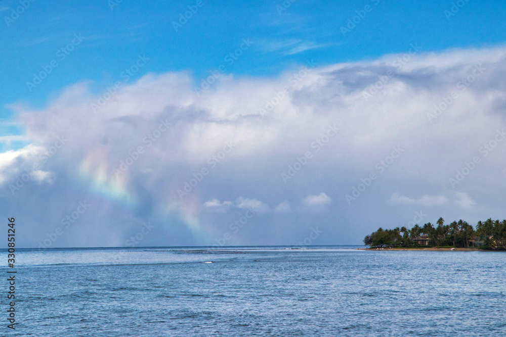 Rainbow cloud on the horizon on Maui.