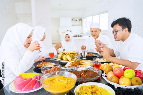 Asian muslim family eating and drinking together