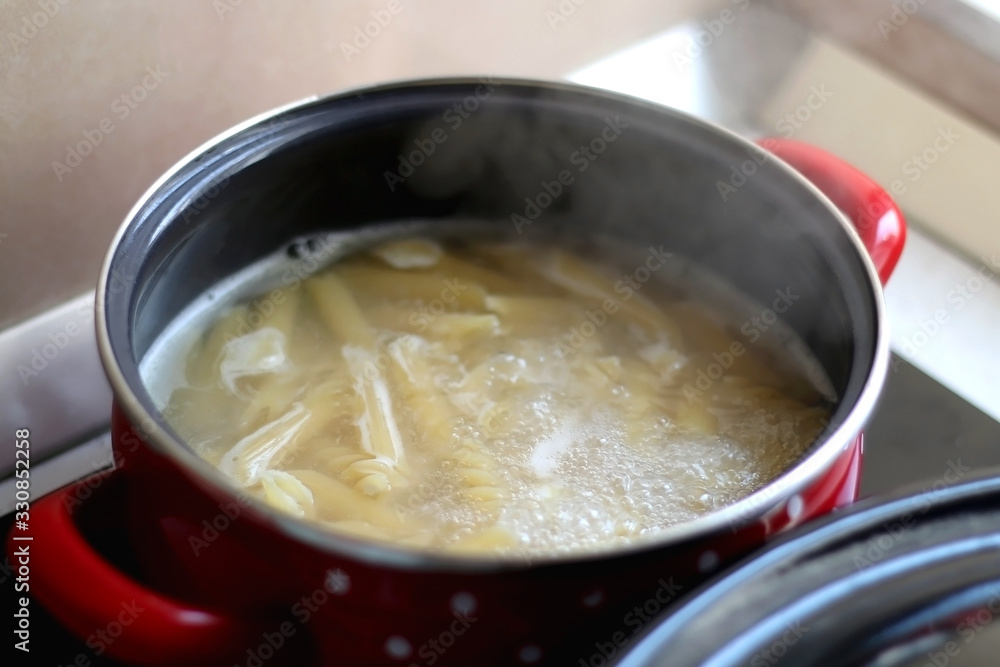 Cooking pasta in boiling water. Selective focus. Cooking pasta in boiling water. Selective focus.