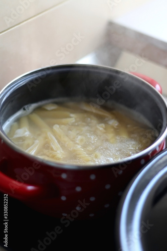 Cooking pasta in boiling water. Selective focus.