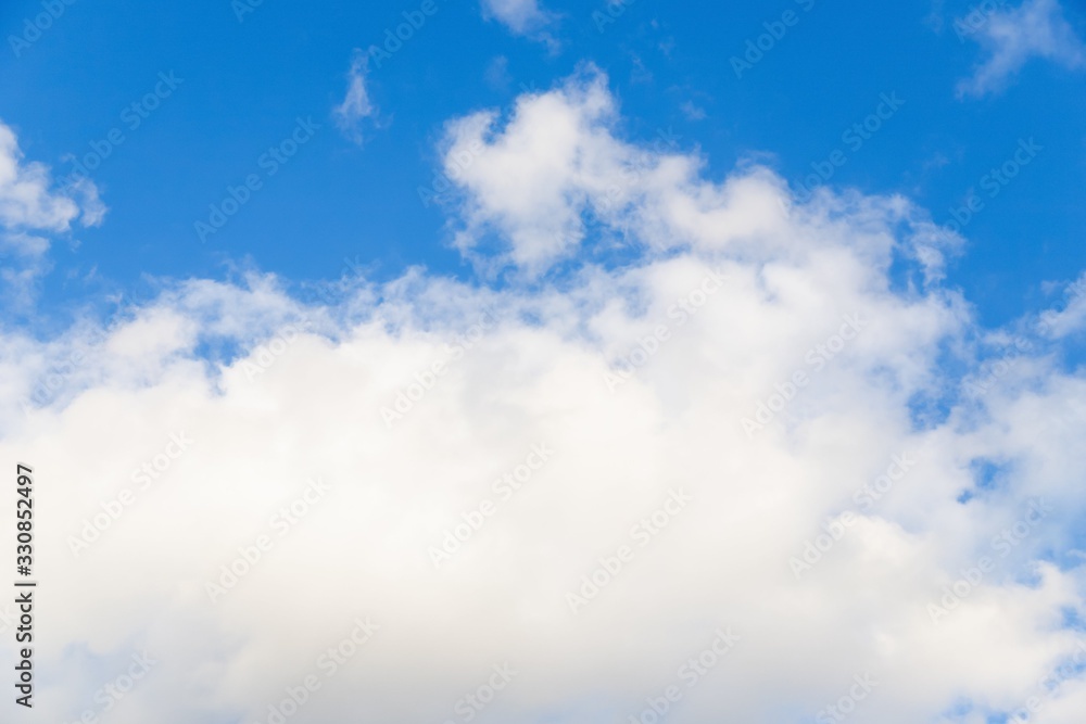 Fototapeta premium Beautiful white big soft fluffy cloud on a clear blue sky background