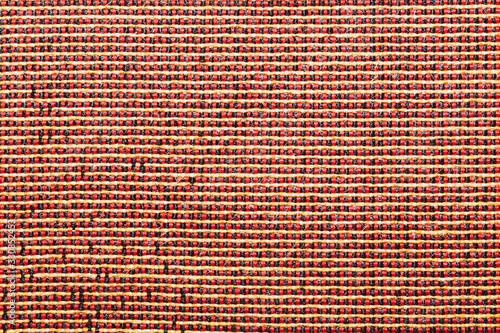 Fabric texture with red threads. textile background extremely close up. woven pattern