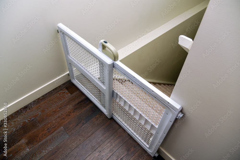 Baby gate at top of staircase - obrazy, fototapety, plakaty 