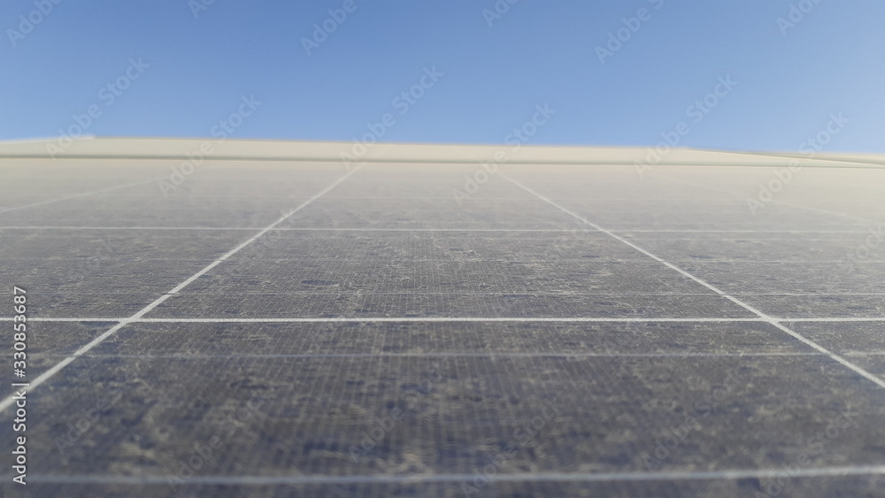 close-up and detail of sand, dust and dirt on a solar panel impacting the efficiency of solar electricity power generation