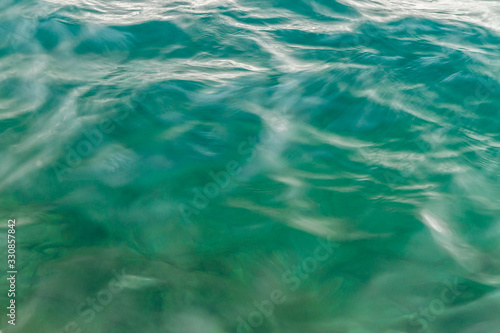 Blurry green sea water surface in motion