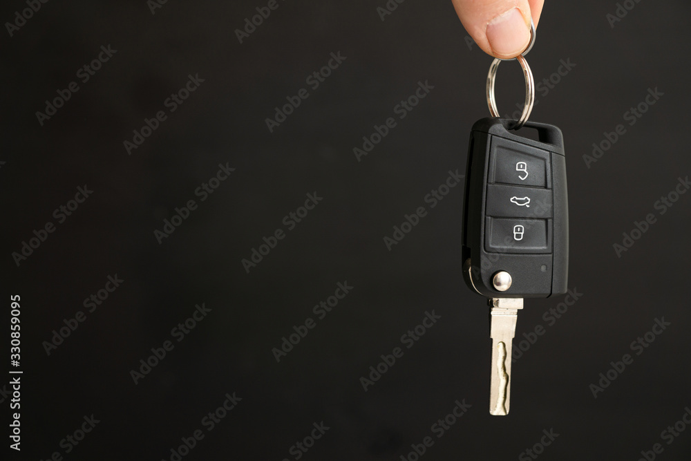 person holding key in hand and black background person holding key in hand and black background