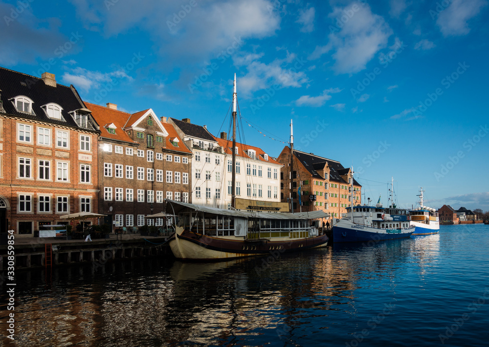 Famous old harbour with boats and colorful old buildings in Copenhagen