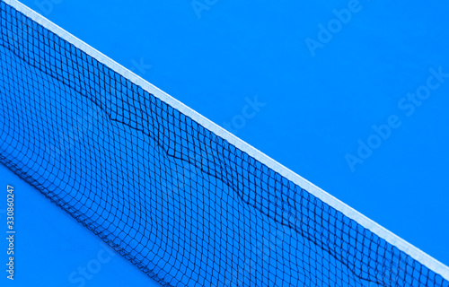 Blue paddle tennis net and hard court. Tennis compettion concept