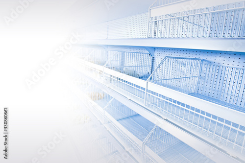 Disappearance of products from the shelves. Concept - lack of products in the store. Deficiency in food products. Place for an inscription. Empty shelves in the supermarket. White empty shelving