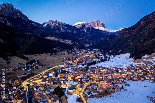 Night aerial view of Pozza di Fassa, a commune in Trentino at the northern Italia. Val di Fassa, Dolomiti