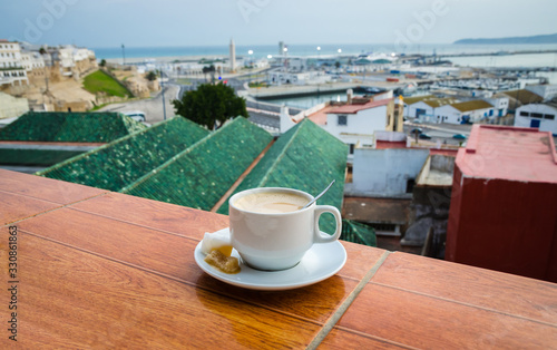 Cup of coffee and panorama of old medina in city Tangier, Morocco