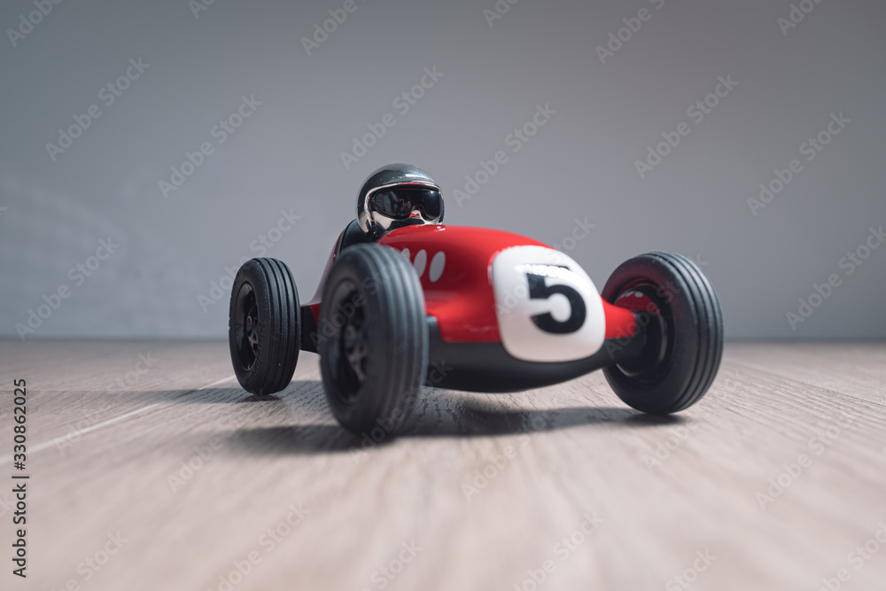 Red racing toy car with number five painted on it
