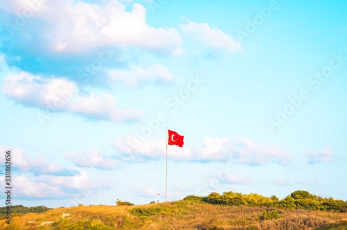 National flag of Turkey on top of the hill
