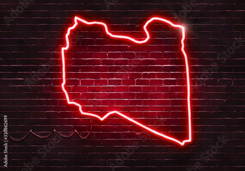 Neon sign on a brick wall in the shape of Libya.(illustration series)
