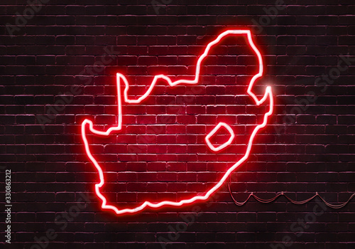 Neon sign on a brick wall in the shape of South Africa.(illustration series)