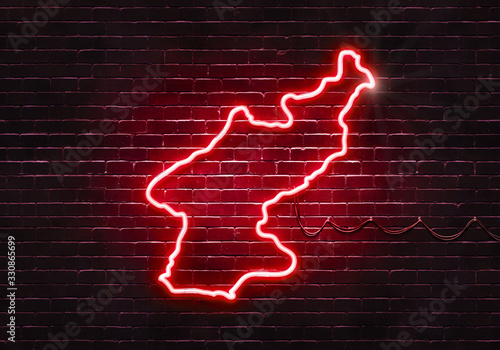 Neon sign on a brick wall in the shape of North Korea.(illustration series)