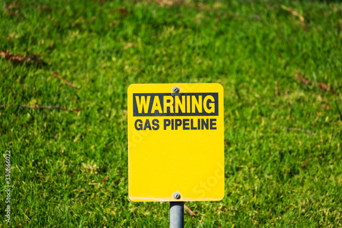 Wallpaper Mural Warning gas pipeline sign with blurred background of green landscape Torontodigital.ca