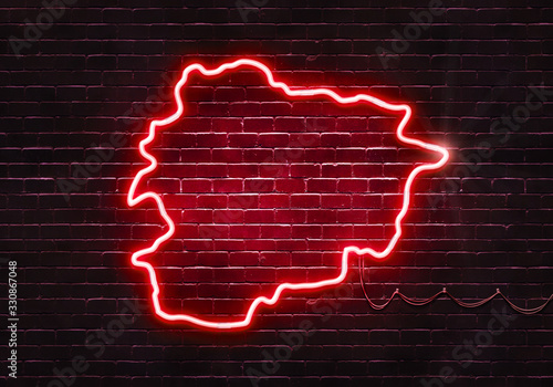 Neon sign on a brick wall in the shape of Andorra.(illustration series)