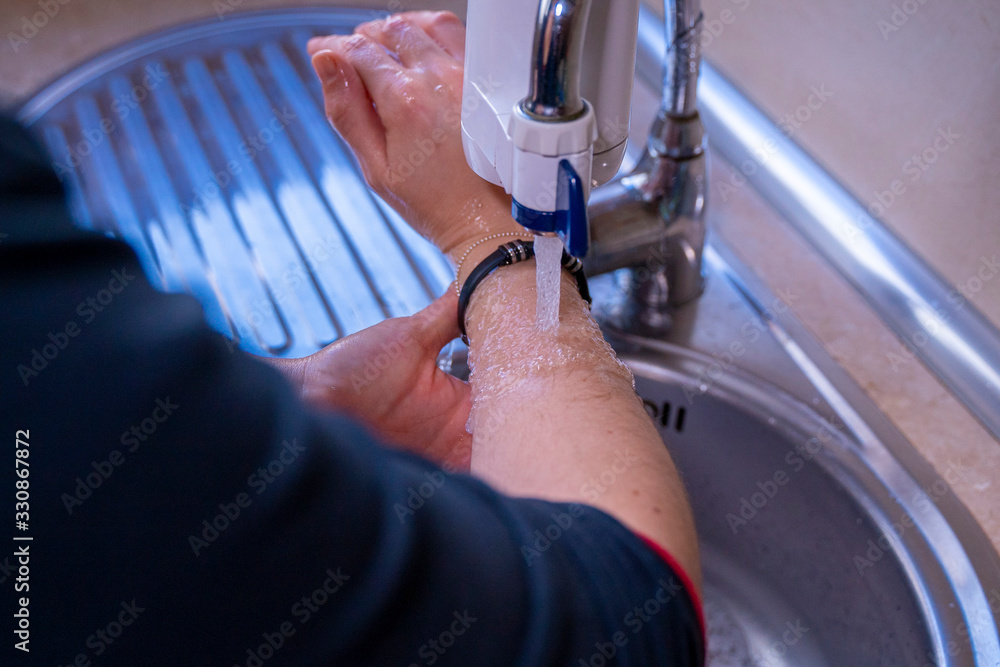 Washing arms properly. Hygiene concept. Wet hands. Stock Photo Adobe