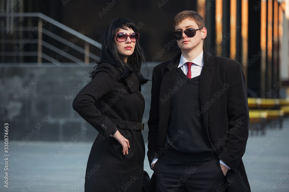 Young fashion business couple on city street Young fashion business couple on city street