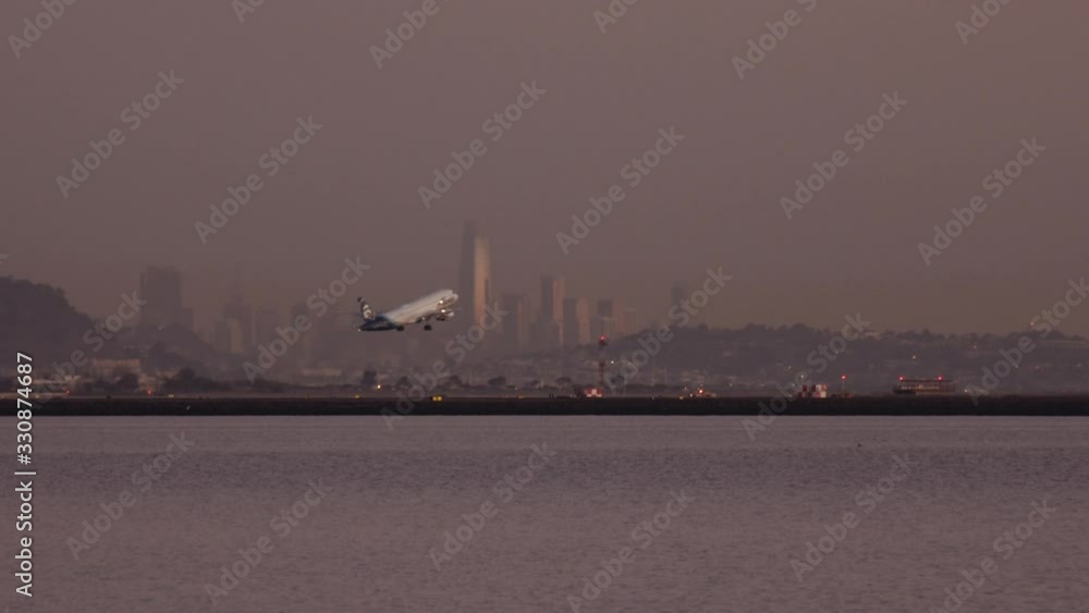 Airplaine Taking Off with the View of City Buildings in Background Airplaine Taking Off with the View of City Buildings in Background