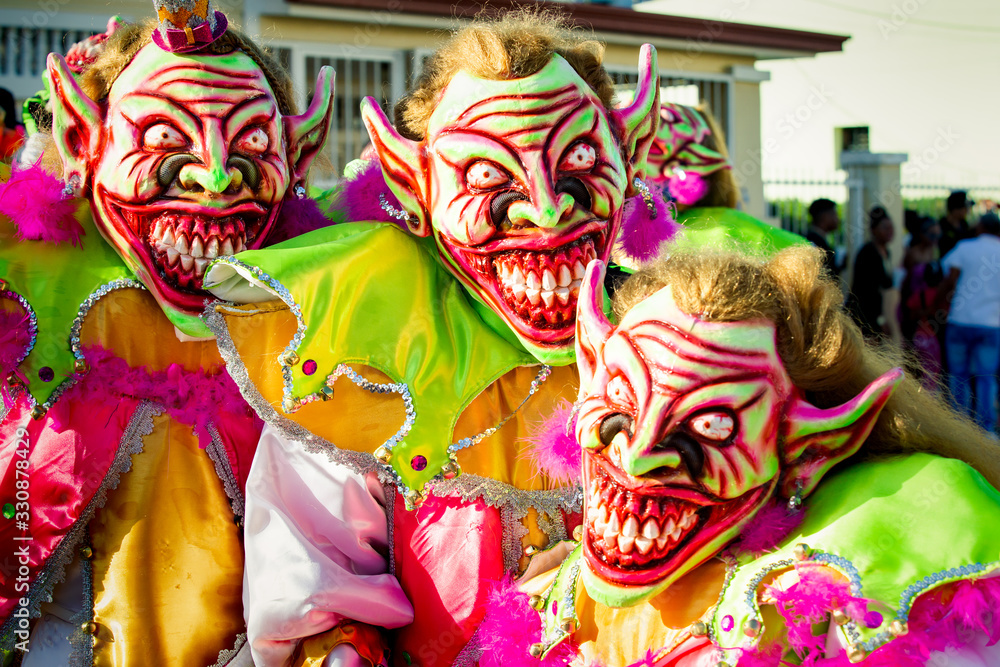 closeup men in pied scary clowns costumes pose for photo at dominican carnival