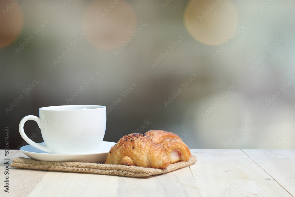 Croissant and coffee on wood table Croissant and coffee on wood table