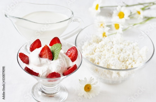 cheese cream. whipped curd cream with strawberries. Homemade cottage cheese is whipped with cream. Chamomile flowers. A useful dessert. On a light background.