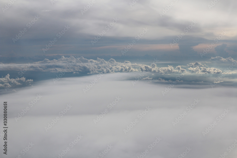 Dramatic cloudscape during sunset from the airplane's window