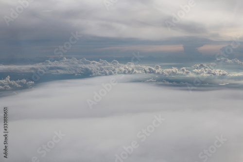 Dramatic cloudscape during sunset from the airplane's window © Crystaltmc