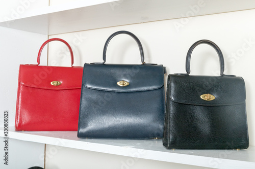 vintage leather bag on the white shelf - Image 
