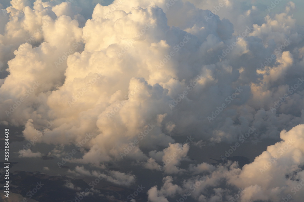 Dramatic cloudscape during sunrise from the airplane's window Dramatic cloudscape during sunrise from the airplane's window