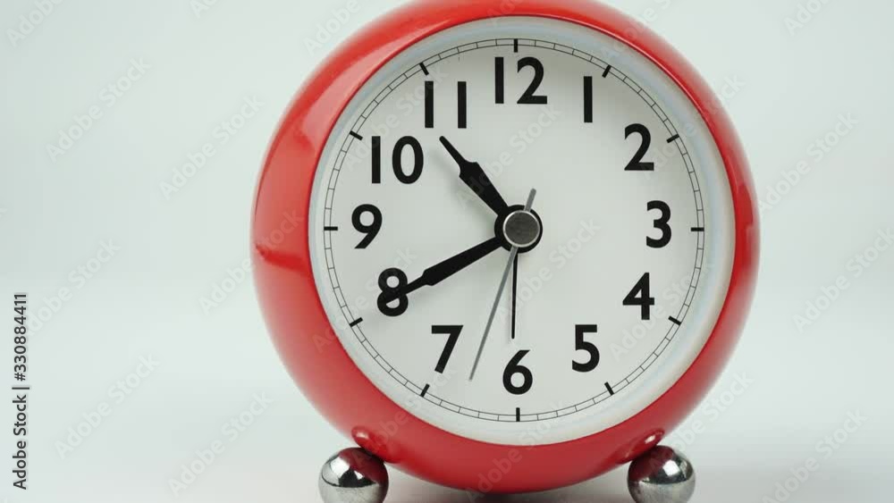 Move the camera angle from left to right, Red alarm clock beginning of time 10.30 run fast. Time passing 60 minutes. Time lapse moving fast on white background. Move the camera angle from left to right, Red alarm clock beginning of time 10.30 run fast. Time passing 60 minutes. Time lapse moving fast on white background.