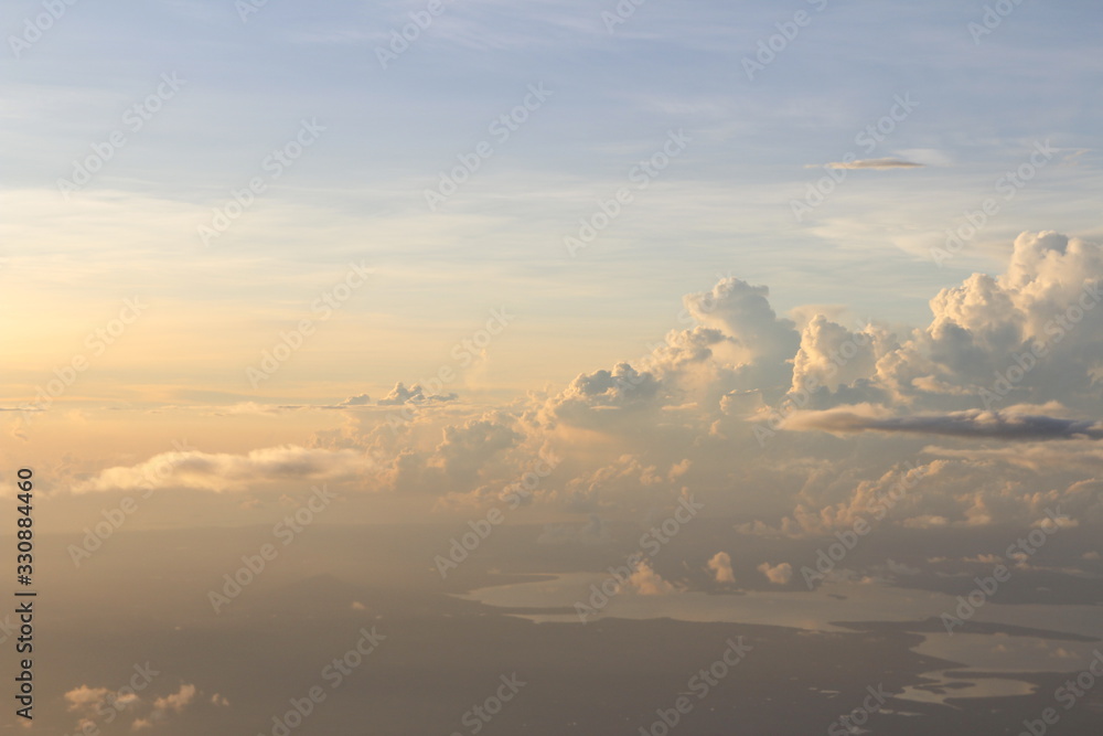 Dramatic cloudscape during sunrise from the airplane's window