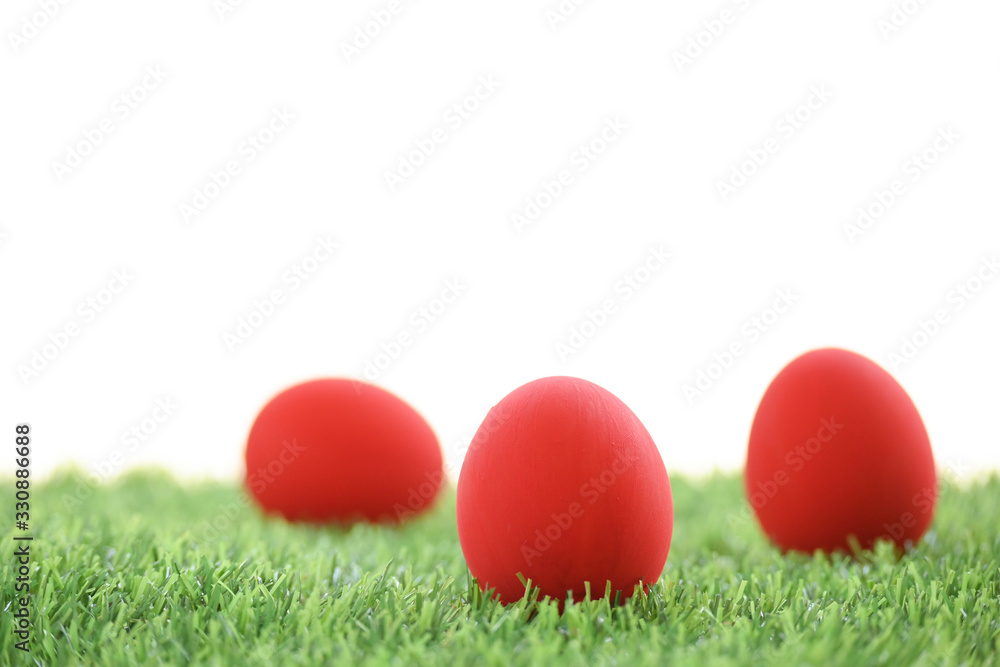 red easter egg on lawn green grass artificial with blank white background red easter egg on lawn green grass artificial with blank white background