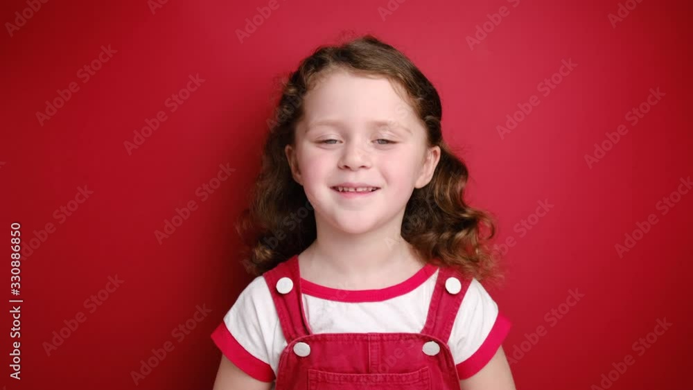 Relaxed little curly girl enjoying good smell or pleasant fragrance, serene mindful child taking deep breath feel no stress free inhaling fresh air relaxing isolated on red studio background Relaxed little curly girl enjoying good smell or pleasant fragrance, serene mindful child taking deep breath feel no stress free inhaling fresh air relaxing isolated on red studio background
